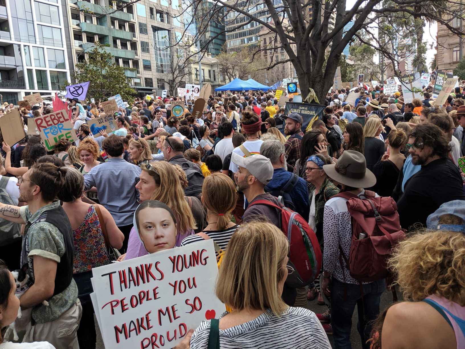 Image of hundreds of participants at the climate rally held in Melbourne. One visible sign reads "Thanks young people for doing this for our future"