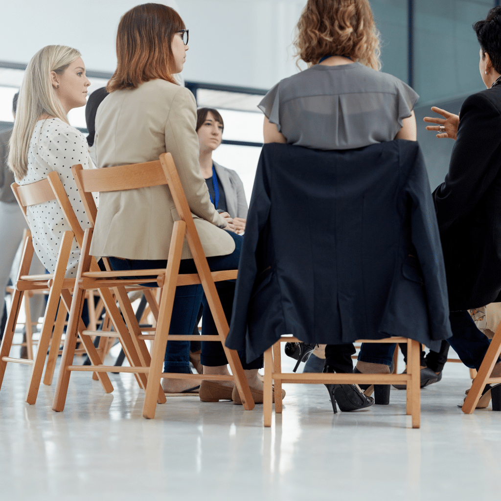 A group of people sitting in a circle having a discussion